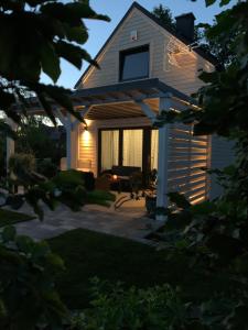 a house with a lit up backyard at night at Lilla House in Sasino