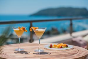 two cocktails on a table with a plate of fruit at Iberostar Waves Slavija in Budva