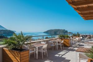a view of the ocean from a restaurant with tables and chairs at Iberostar Waves Slavija in Budva