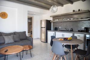 a living room with a couch and a table at Passa Corda Suites with amazing view in Galanádhon