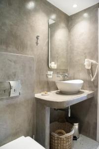 bagno con lavandino e specchio di Passa Corda Suites with amazing view a Galanádhon
