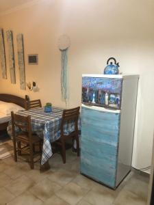Megás Limniónas的住宿－陽光公寓，一间带桌子和冰箱的用餐室