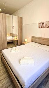 1 cama blanca grande en una habitación con 2 lámparas en Grotta Maratti, en Camerano