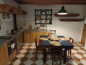 a kitchen with a table with chairs and a stove at Casa Mali in Cres