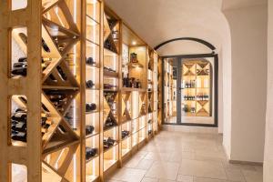 a wine cellar with a wall of wine bottles at Domaine et Château de Valinches in Marols