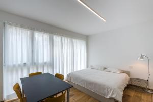 Llit o llits en una habitació de Modern Studios Mendrisio