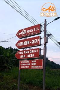 a sign for a restaurant with lots of signs at Ha Giang Ali Hostel in Ha Giang