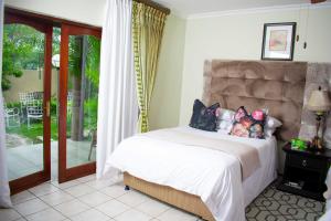 a bedroom with a bed with a stuffed animal on it at Tengo guest house in Phalaborwa