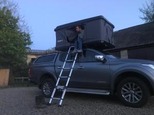 a person sitting on the roof of a pick up truck at Hexham Tentbox Hire in Hexham