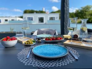 a table with plates of food and glasses of wine at Sonnendeck Rügen in Lohme