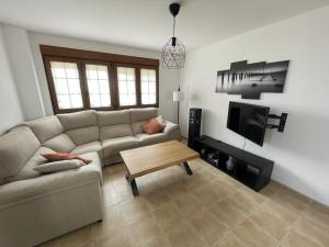 a living room with a couch and a coffee table at Casa La Llosa en Suances in Suances