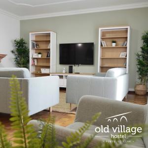 a living room with couches and a flat screen tv at Oldvillage Hostel in Ponte de Lima