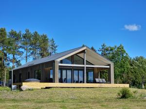 a modern house with a large group of windows at Maasika Villa 