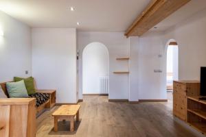 a living room with a couch and a table at Rodella A Parte in Campitello di Fassa