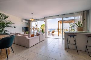 a living room with a couch and a table at Attico blu - Sea View Penthouse in Kos Town