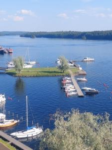 a group of boats docked in a large body of water at Malminranta in Savonlinna