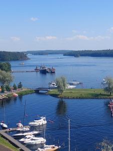 a group of boats docked in a large lake at Malminranta in Savonlinna