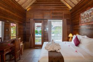 Ένα ή περισσότερα κρεβάτια σε δωμάτιο στο Rijet Villa Beach & Restaurant +105 φωτογραφίες
