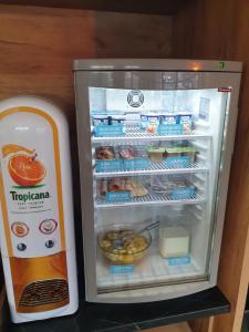 a refrigerator with an open door with food inside at Kyriad Direct Martigues in Martigues