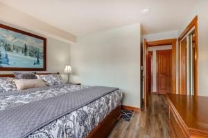 a bedroom with a bed and a wooden floor at Powderhorn Lodge 214 Perfect Solitude Escape in Solitude +36 photos