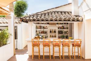 a bar on the patio of a house at Hôtel La Tartane Saint-Tropez in Saint-Tropez