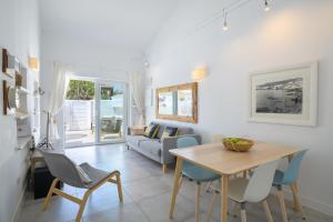 a dining room and living room with a table and chairs at Casa Capricho in Puerto del Carmen