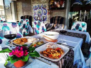 a table with two plates of food and glasses of wine at Yağız İndigo Blue in Şile