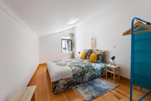 een slaapkamer met een bed en een blauwe dressoir bij Casa Canopa in Setúbal