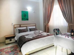a bedroom with two beds and a table and a window at Yağız İndigo Blue in Şile
