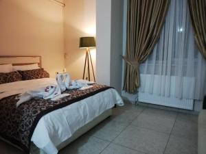 a bedroom with a bed with towels on it at Yağız İndigo Blue in Şile