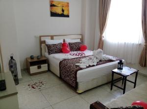 a bedroom with two beds with red pillows at Yağız İndigo Blue in Şile