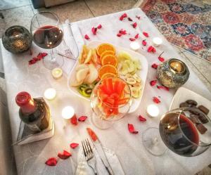 a table with a plate of food and glasses of wine at Yağız İndigo Blue in Şile