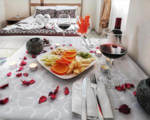 a table with a plate of food and two glasses of wine at Yağız İndigo Blue in Şile