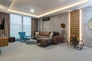 a living room with a couch and a chair at Korzo Apartments Visoko in Visoko
