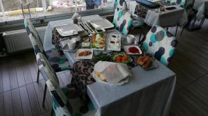a table with plates of food on it with chairs at Yağız İndigo Blue in Şile