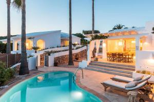 a villa with a swimming pool and a house at Villas Etnia in Binissafuller