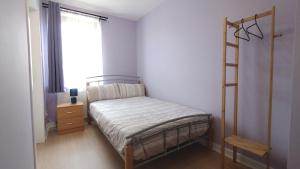 a small bedroom with a bed and a window at Aria Lodging Inverness in Inverness