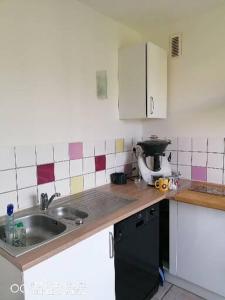 a kitchen with a sink and a counter top at Bain de soleil in Forcalquier