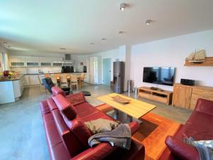 a living room with a couch and a table at Ferienhaus Corvin in Göhren