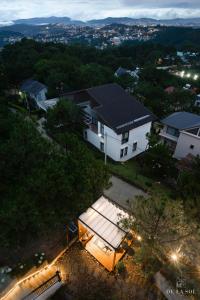 an overhead view of a white house with a courtyard at De La Sol Villa Dalat in Da Lat +152 photos