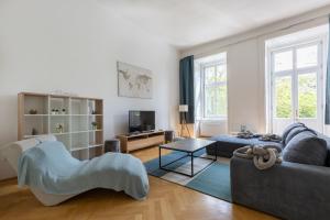 a living room with a couch and a table at SUPER CENTRAL 2BR-2BT with Balcony&View&Sauna&Jacuzzi in Budapest