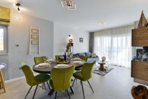 a dining room and living room with a table and chairs at Villa Porta Maris in Zadar