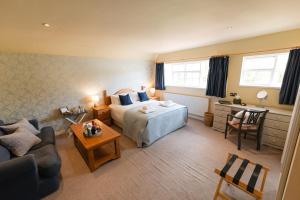 a bedroom with a bed and a living room at Fox And Hounds Llancarfan in Barry +52 photos