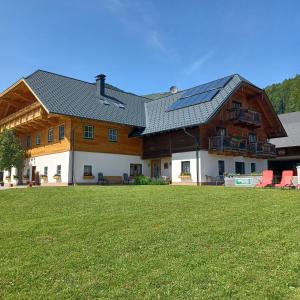 a large house with solar panels on the roof at Auerhiasbauer in St. Wolfgang