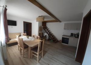 a kitchen and dining room with a table and chairs at Casa Zorilor in Şugag