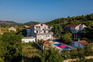 a villa with a swimming pool in a village at APARTMENTS ANA in Umljanović