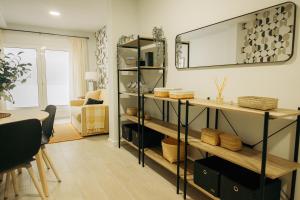 a living room with a table and a mirror at Club Apartments by Grupo Compostelana 1 in Puerto de la Cruz
