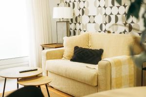 a living room with a couch with a pillow on it at Club Apartments by Grupo Compostelana 1 in Puerto de la Cruz