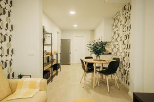 a living room and dining room with a table and chairs at Club Apartments by Grupo Compostelana 1 in Puerto de la Cruz