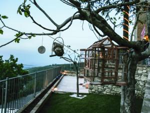 a bird cage hanging from a tree at I Templari di Alberona in Alberona